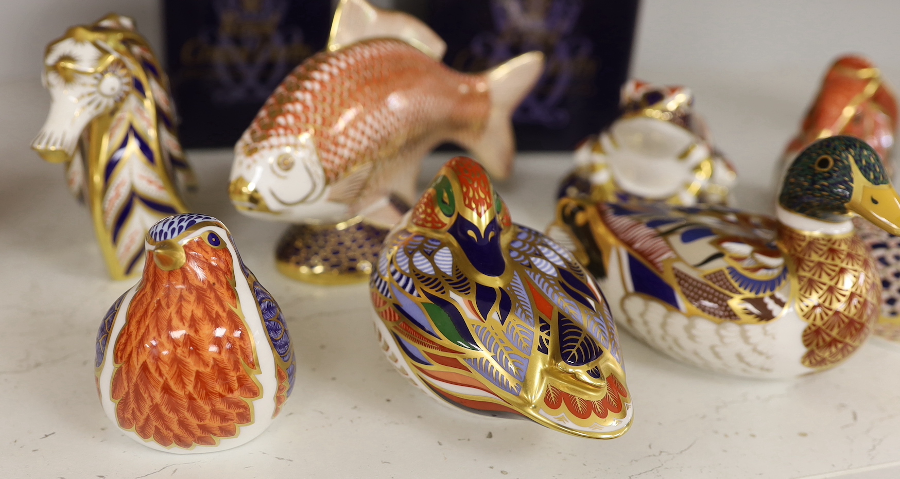 A collection of nine Royal Crown Derby paperweights